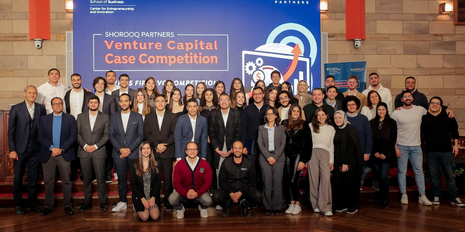 people stand on stage at the Venture Capital Competition