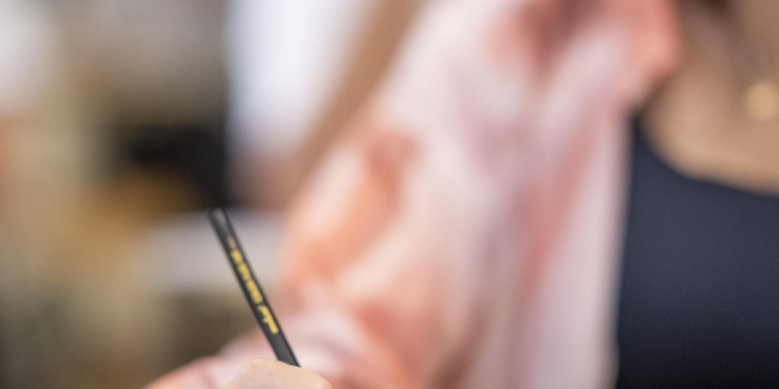 Girl writing in her copybook in class