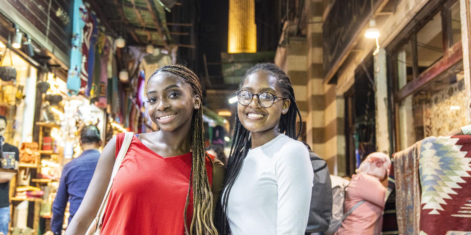Two girls in Cairo old street smiling