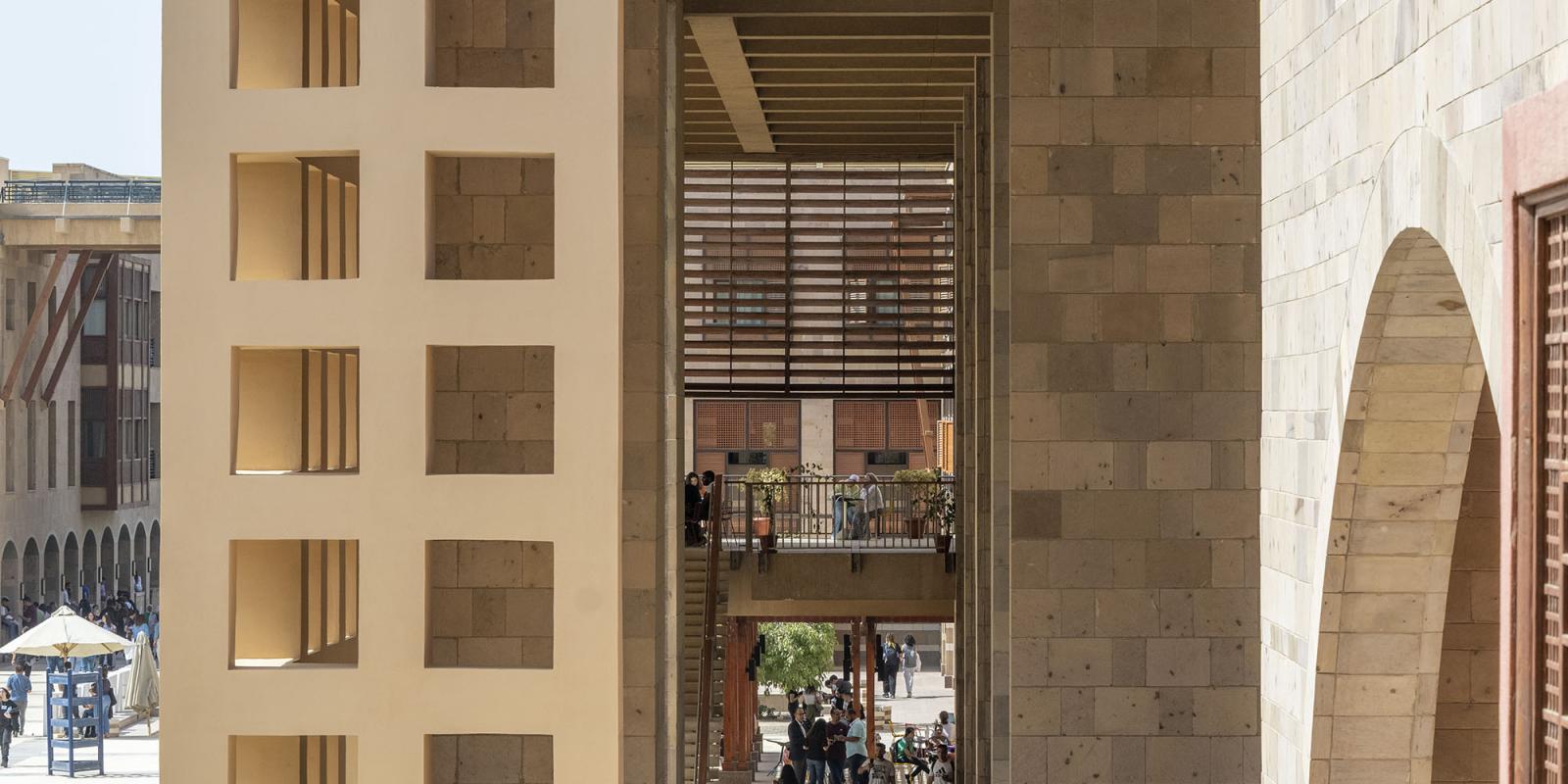 Side of a beige building with hollow square windows