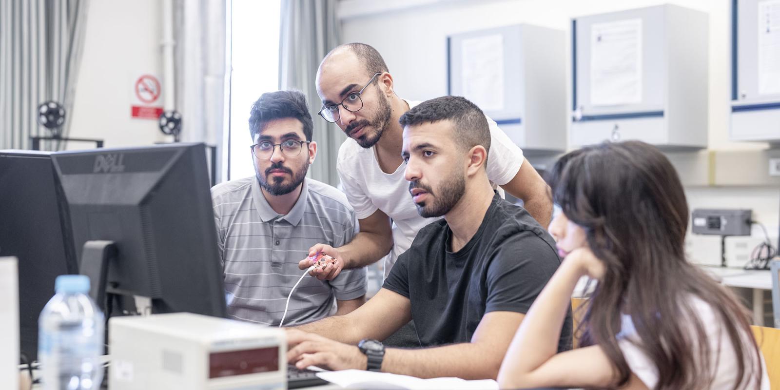 Students in computer lab writing on a keyboard