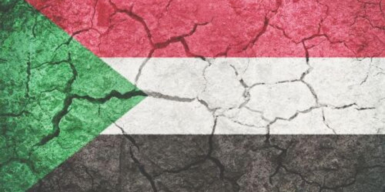 Sudan flag with cracks depicting conflict in the country