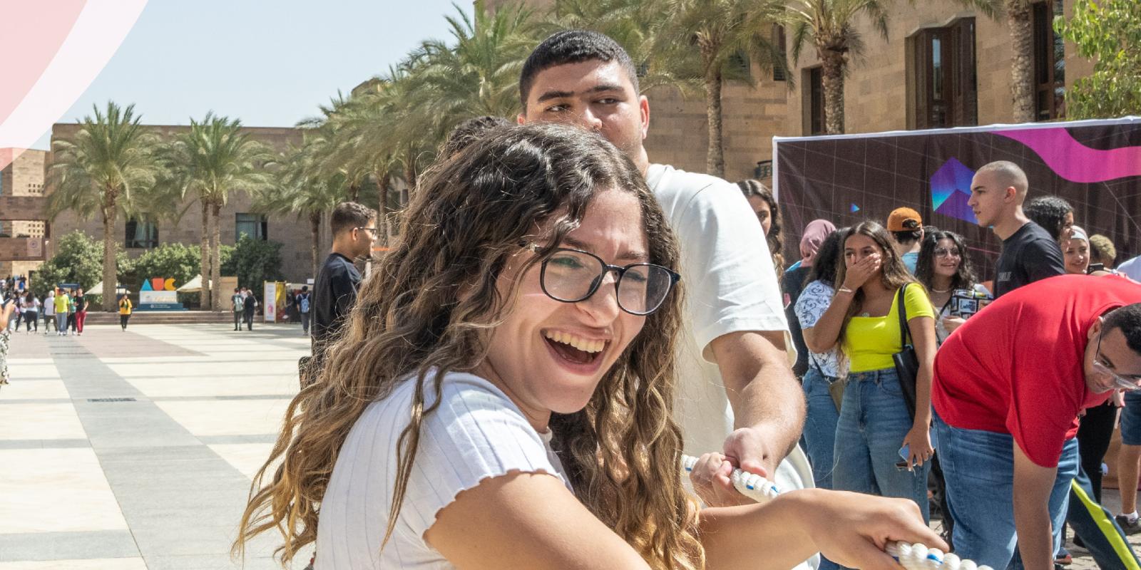 a girl and a boy pulling a rope