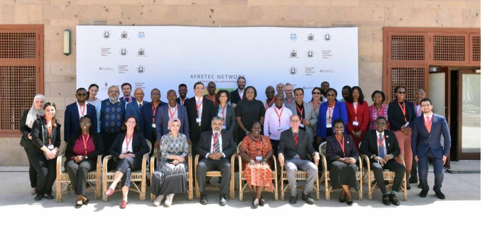 The attendees of the conference pose in a group shot on campus.