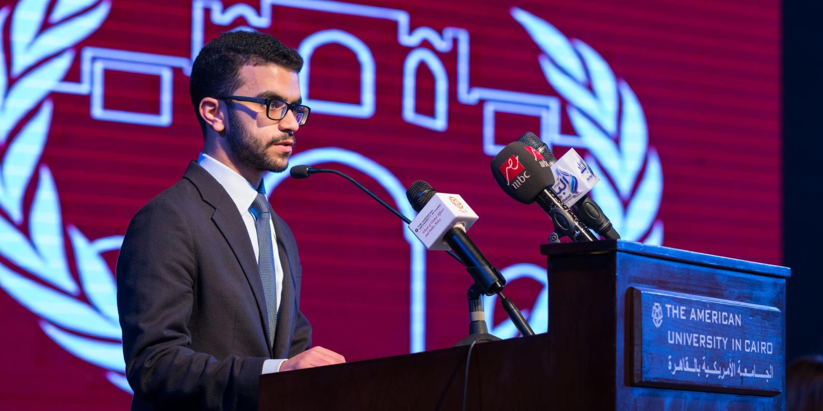 Dual Degree Political Science and International Human Law image of student giving a speech on a podium in a political conference