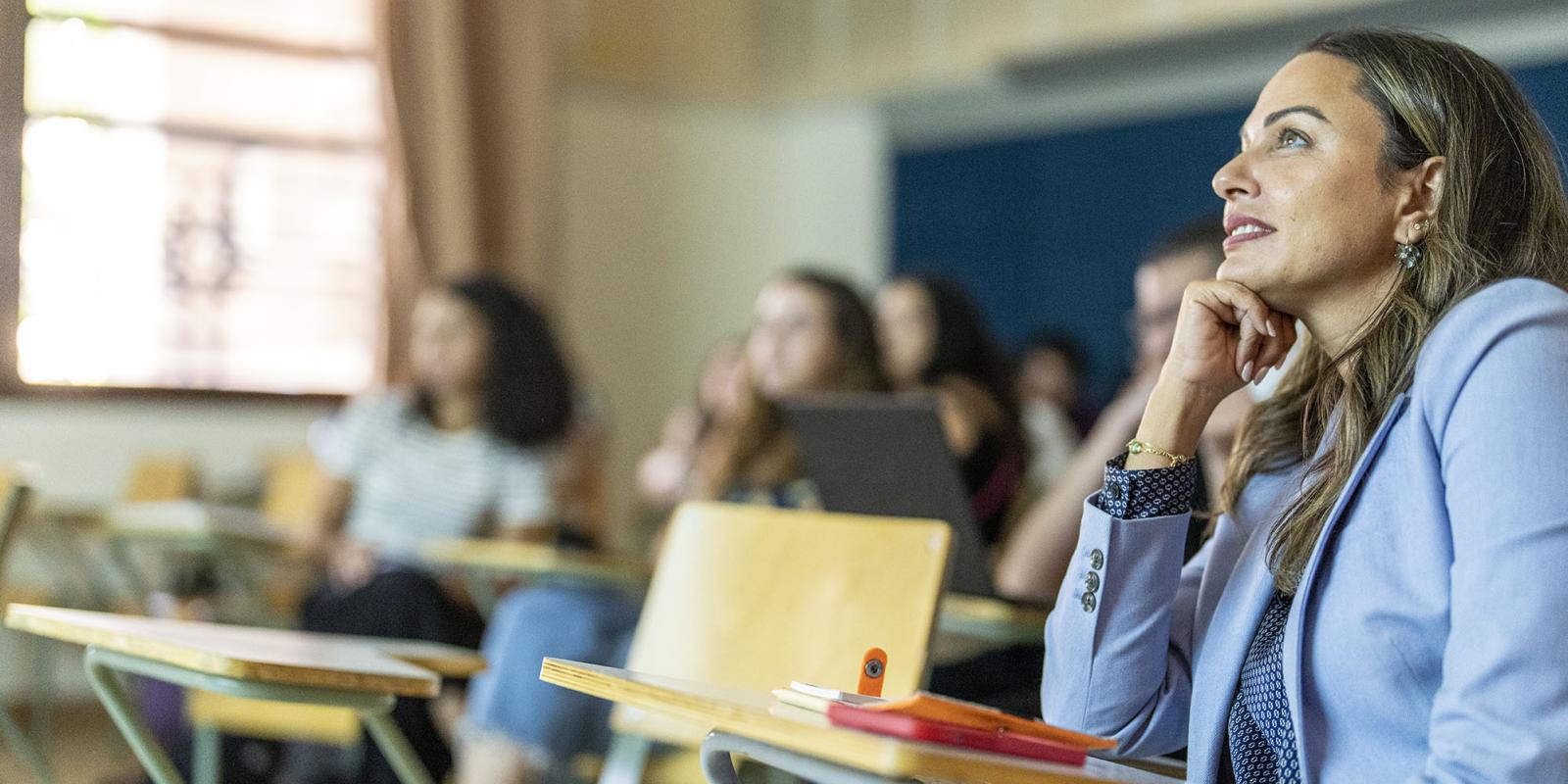 Smiling students in class attending