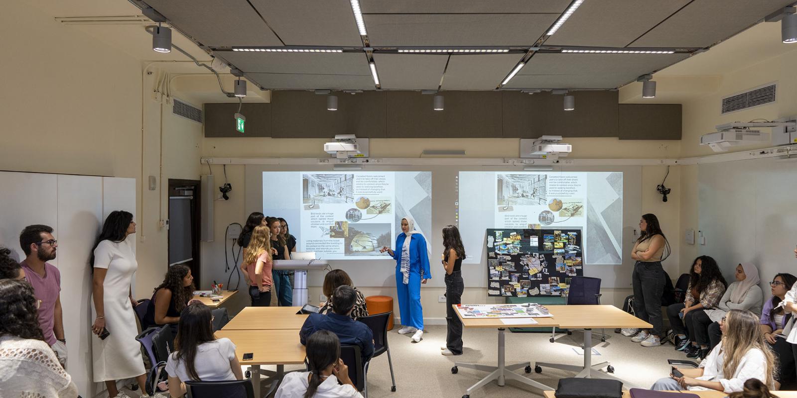 Professor explaining to students green and environmental diagrams