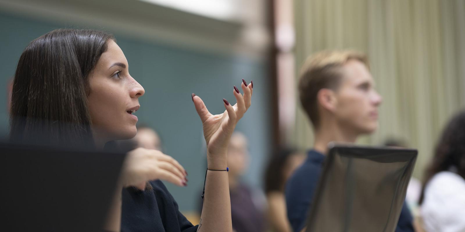 female student explaining information during a class discussion