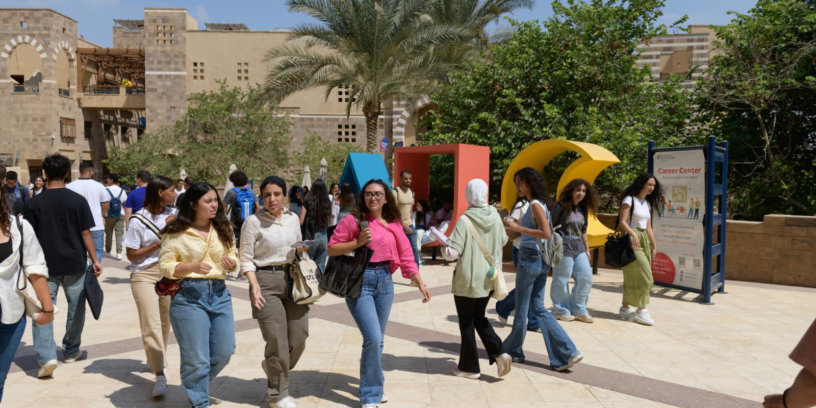 A group of girls walking in AUC Plaza