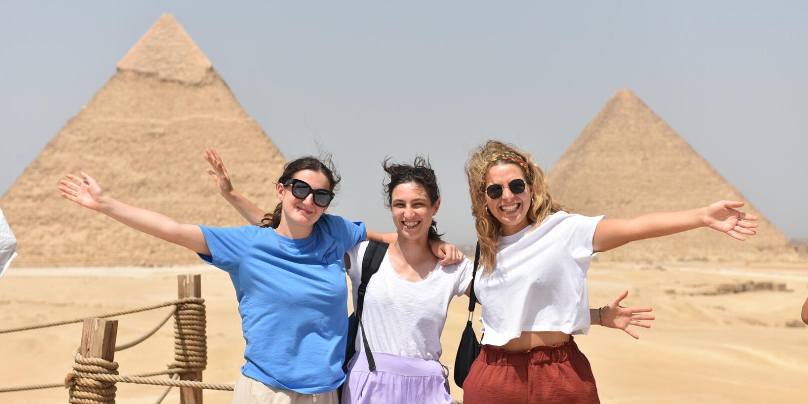 Three girls posing infront of the pyramids