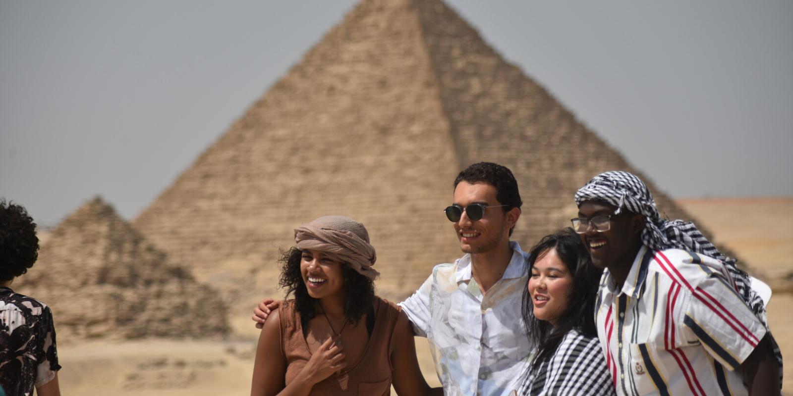 A group of international students taking a picture at the pyramids