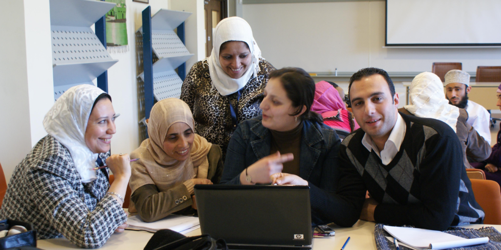 SRC Homepage image of group staff working together in a meeting room