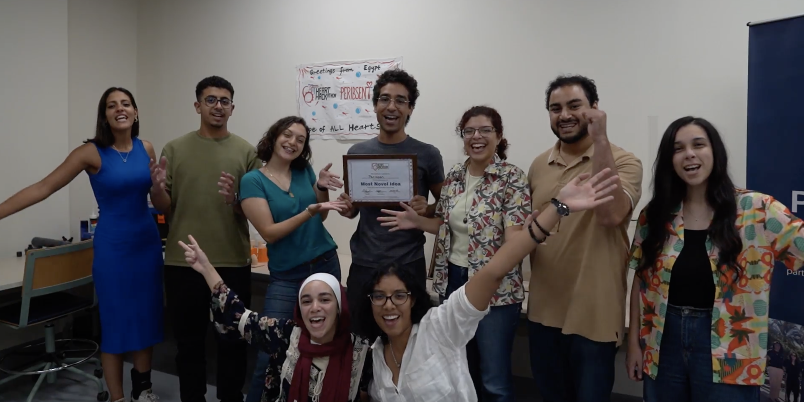 AUC students smiling and holding their Most Novel Idea certificate for their total artificial heart