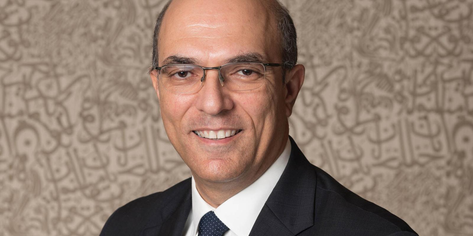 Dean Sherif Kamel smiling against a plain background
