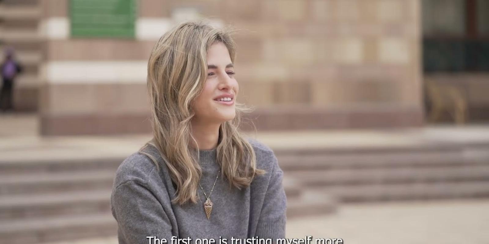 A female is talking and smiling