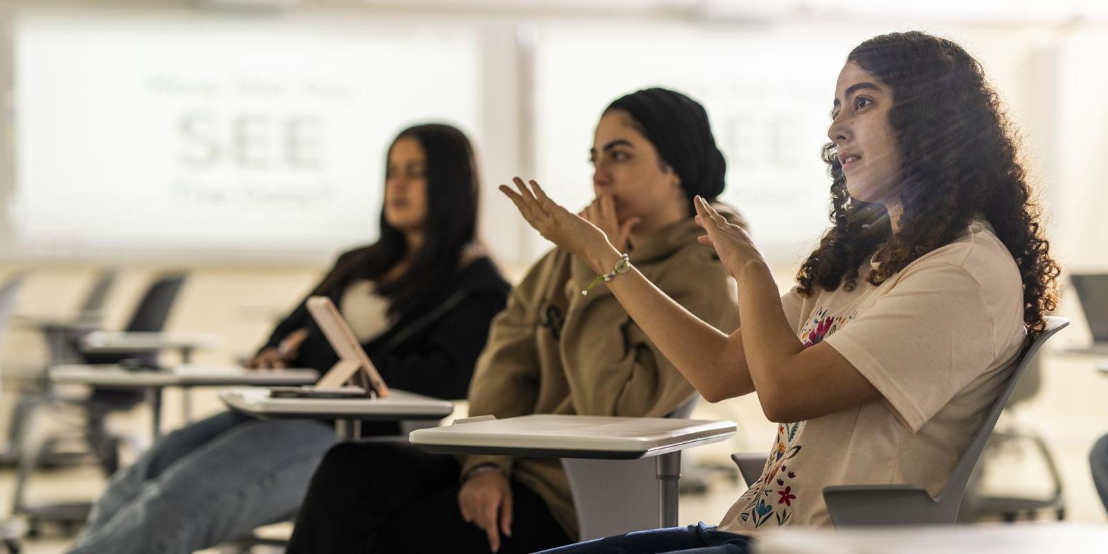 a female student engaging in a class discussion