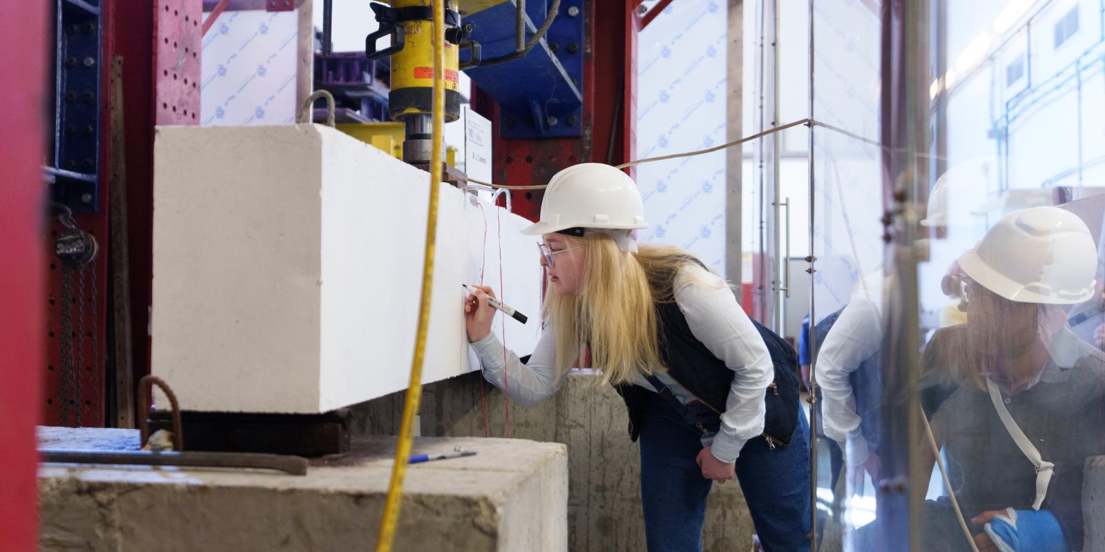 a girl with blond hair wearing a helmet