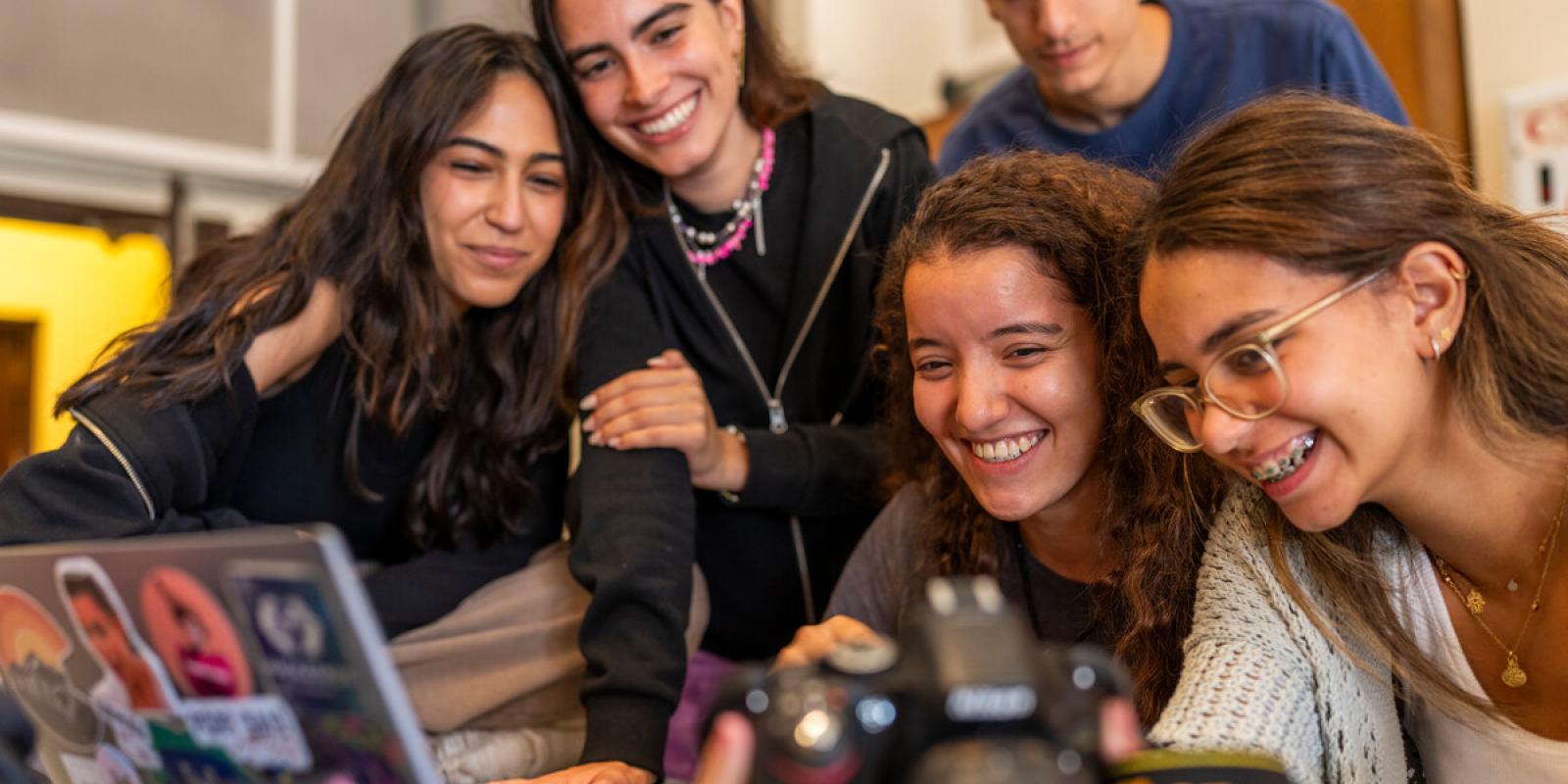 students working with camera and laptop on a project