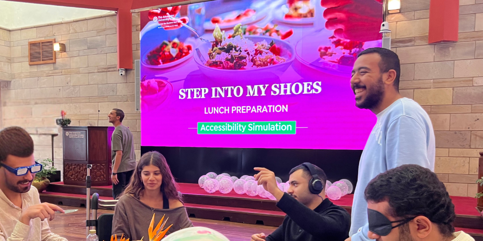 Students participating in the simulation with "stepping into the shoes of others" on the board