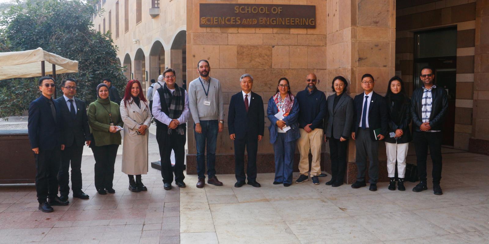 A group of people in front of the School of Sciences and Engineering