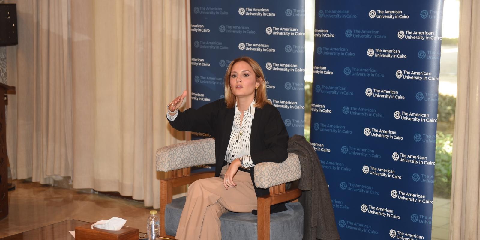 Professor Seham Elmrayed speaks in front of a step-and-repeat