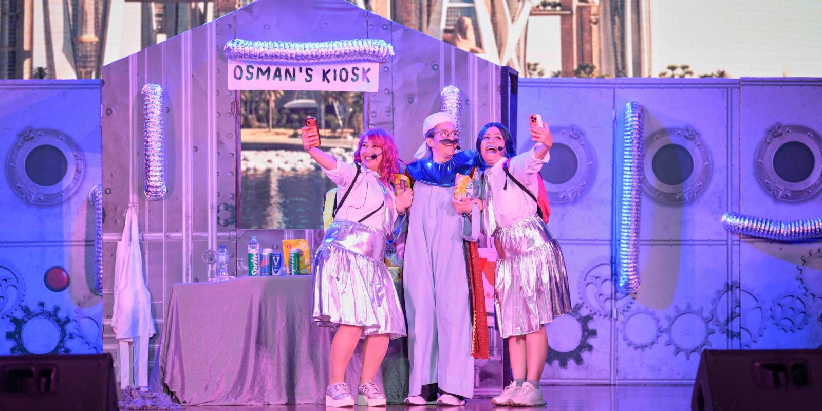 Three performers are on a stage