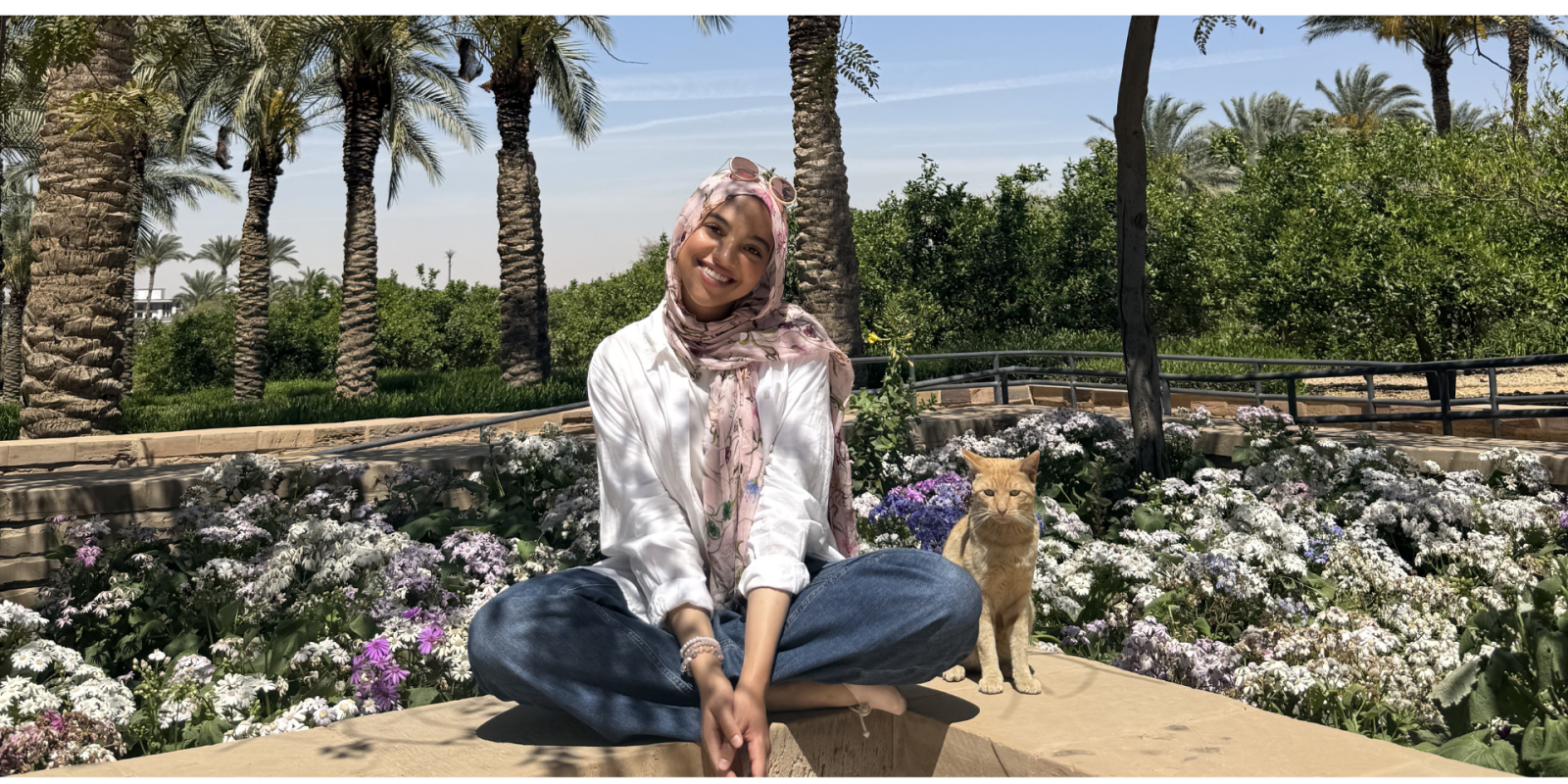Laila sitting in the AUC gardens with a cat