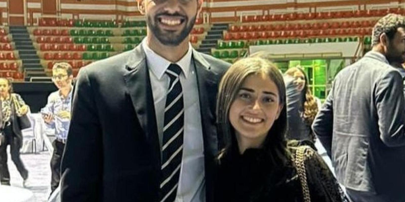 A male and female students standing and smiling