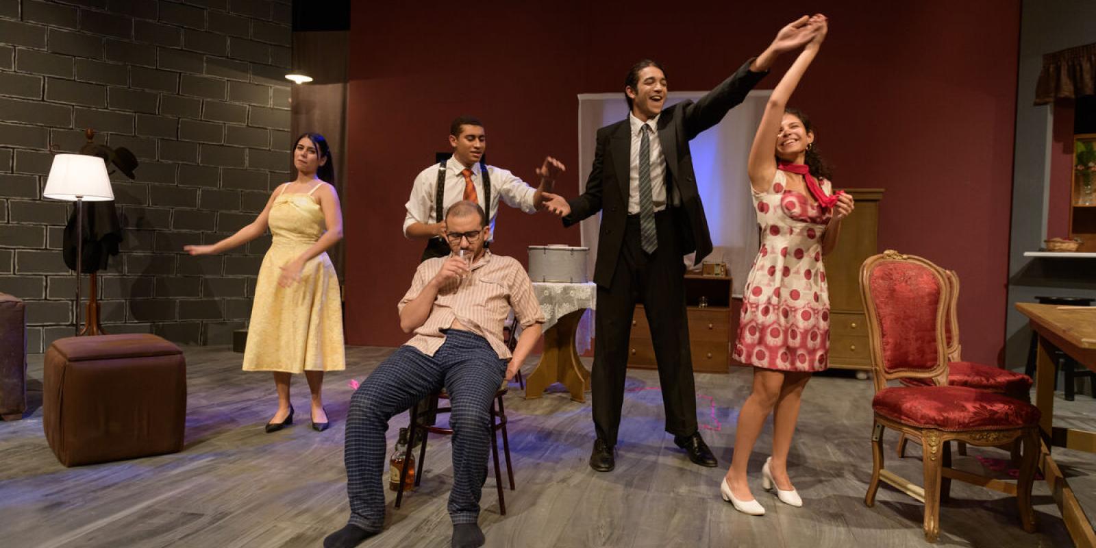 students on stage in a theater production acting