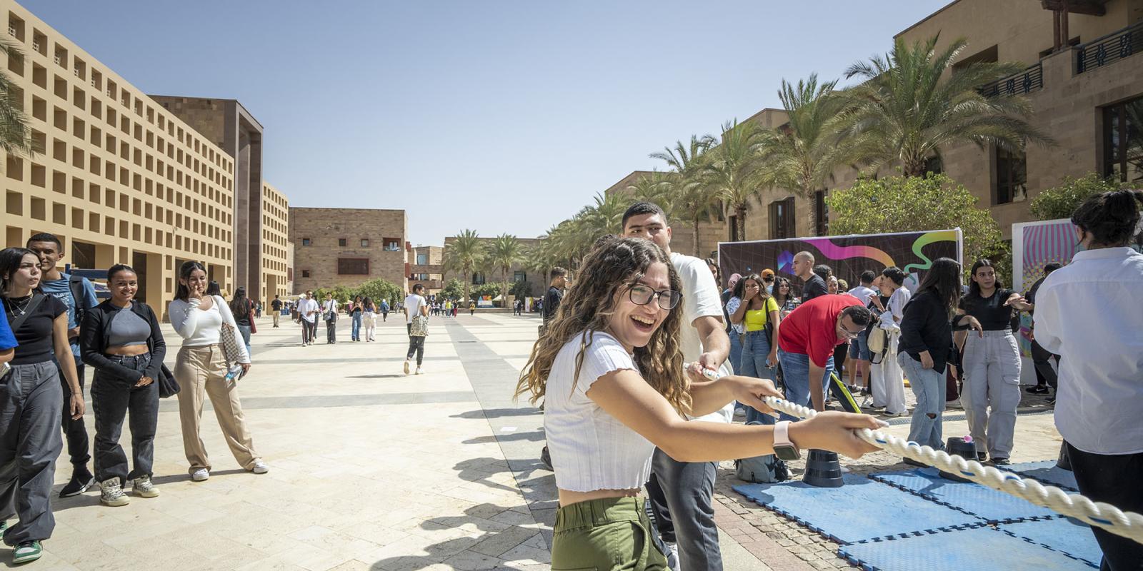 students in tug of war activity in the plaza