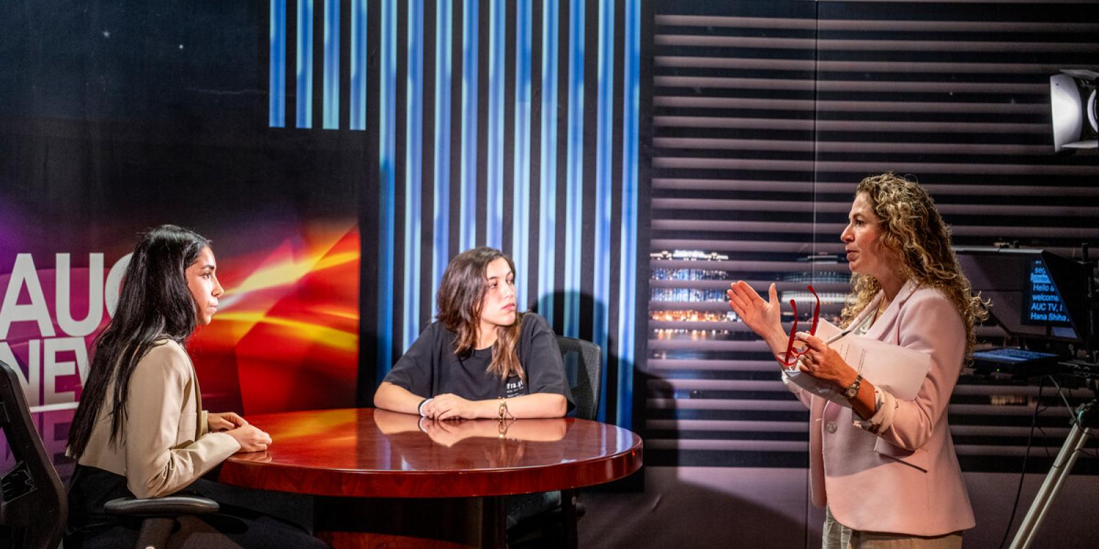 students with professor in tv studio ready for tv production