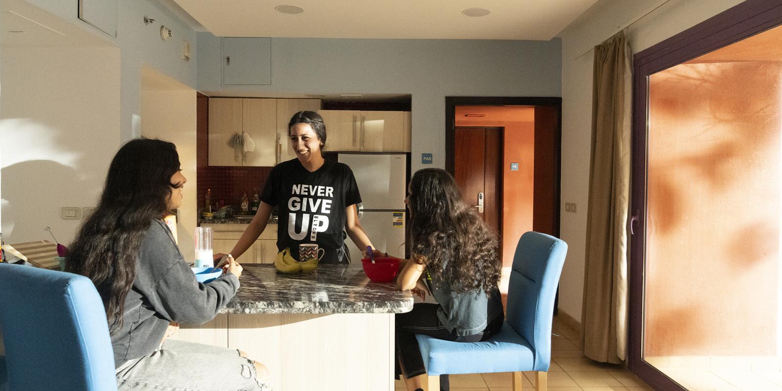 students eating at the kitchen in the auc dorms