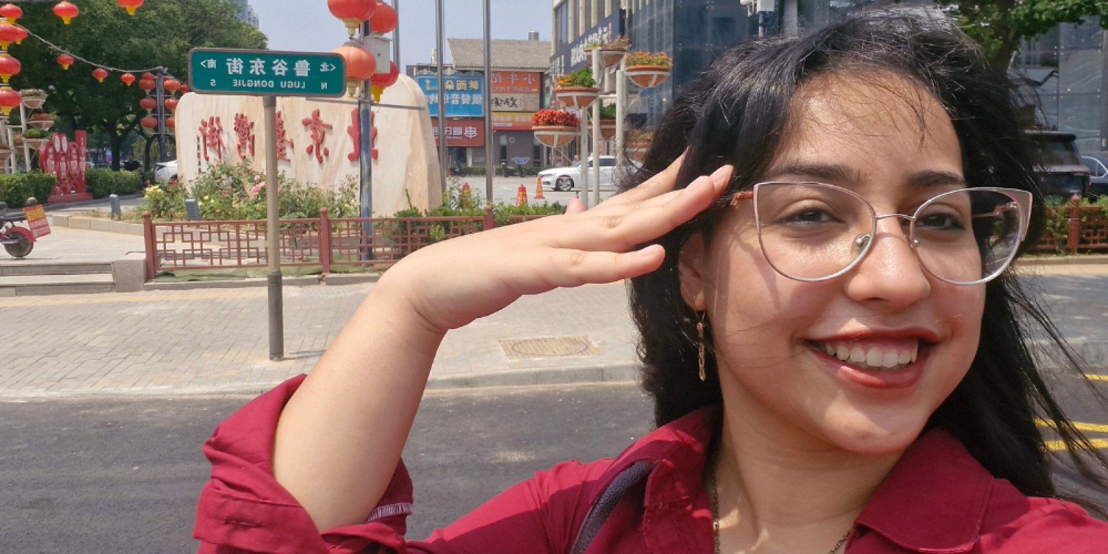 Shahd Younes takes a photo in front of a street