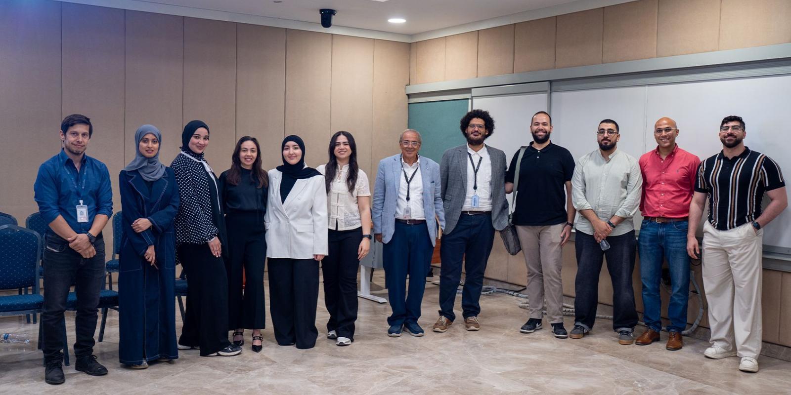 Group of people standing in a line inside a classroom