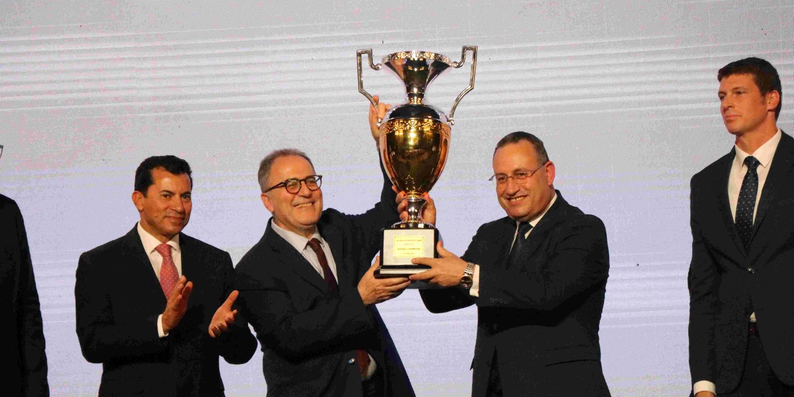 AUC President Ahmad Dallal Holding the All Africa University Games Cup