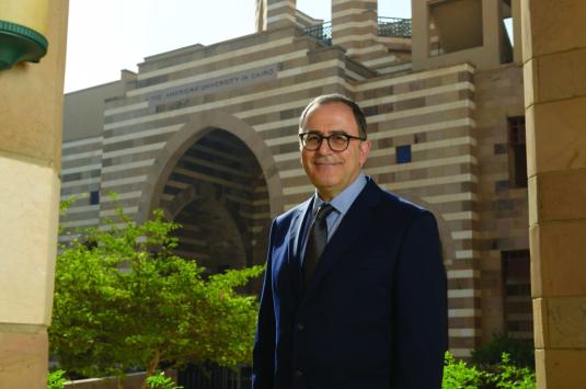 AUC President Ahmad Dallal standing in front of Portal