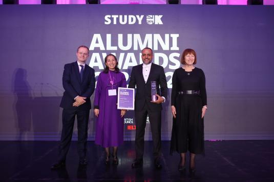 Three people giving award to a man, the Study UK Alumni Award
