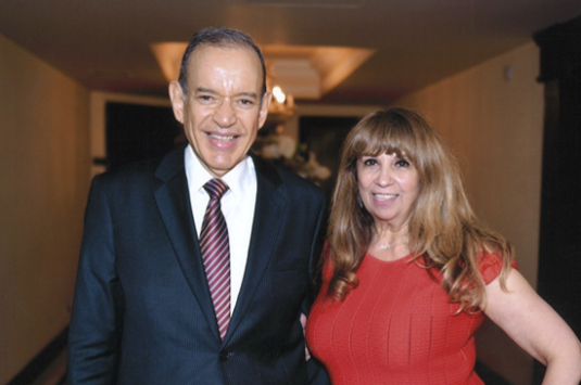 A man and a woman smiling