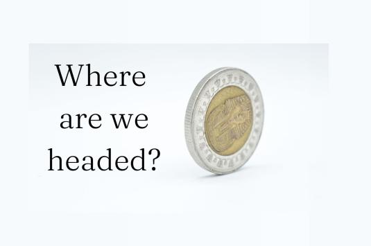A single Egyptian pound coin rolls on its side with the text "Where are headed" in the bottom left