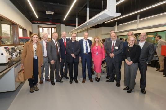The Board of Trustees, faculty and staff visit Eltoukhy Learning Factory, pose in a line in front of lab equipment