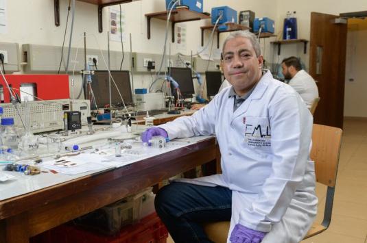 A scientist sitting in a lab