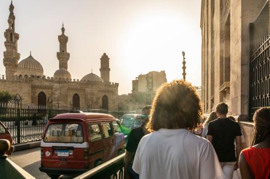 A photo of a Cairo street, taken from Abdelhalim. Al Azhar mosque sits to the left and the wall of Khan al Kalili is on the right. 