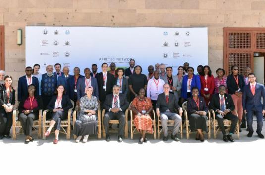 The attendees of the conference pose in a group shot on campus.
