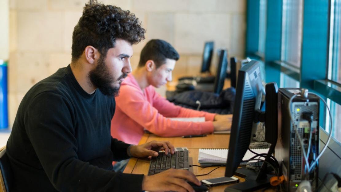 AUC students on the computers in the library 