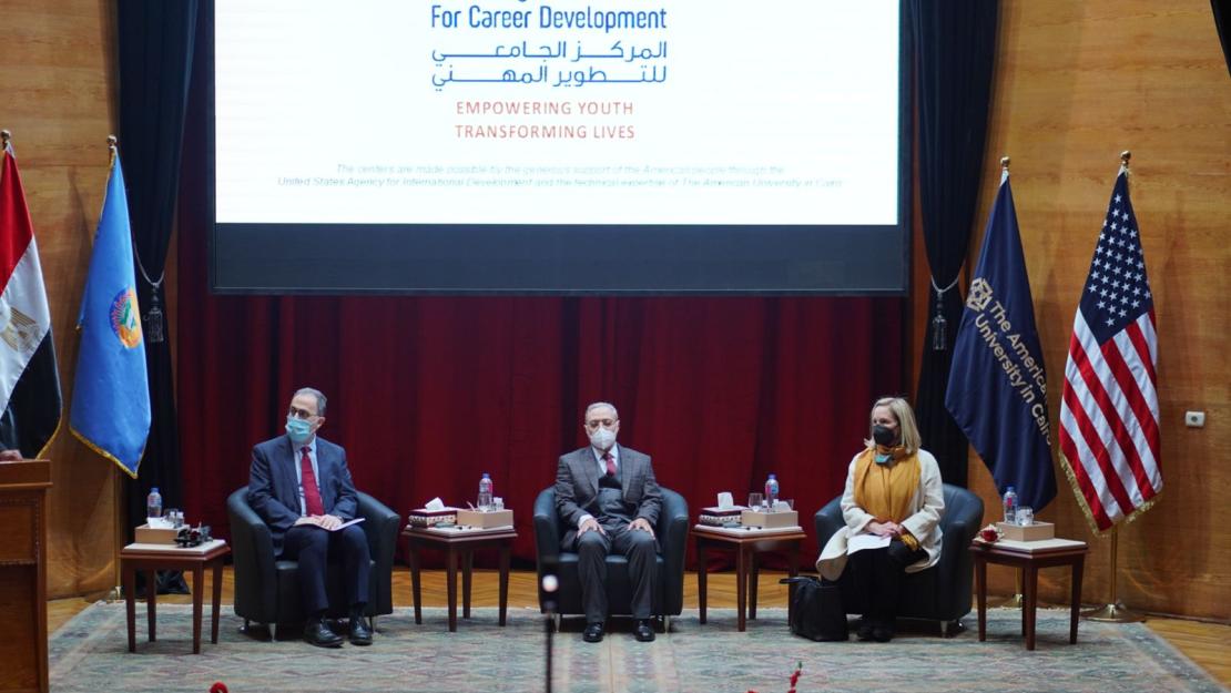 People sitting on stage at the event
