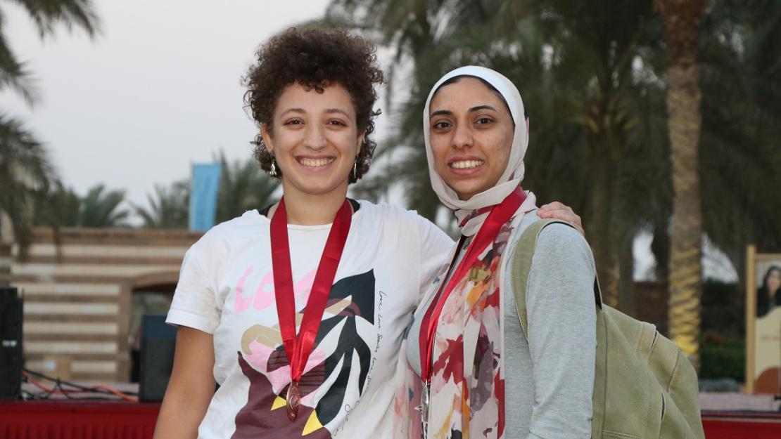 Two women wearing medals