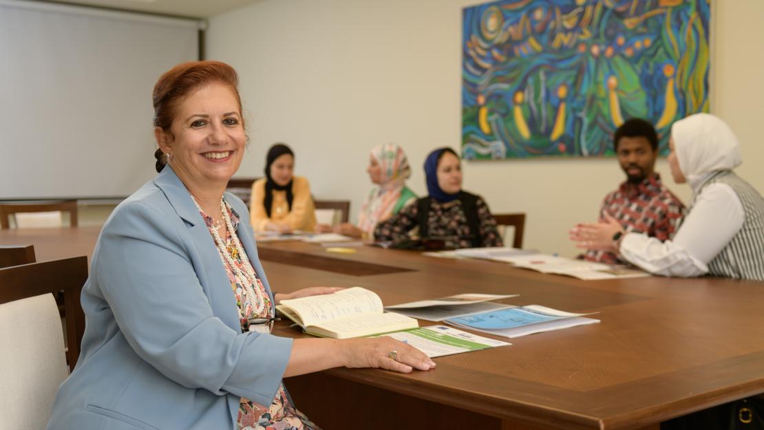 People in class and a woman smiling