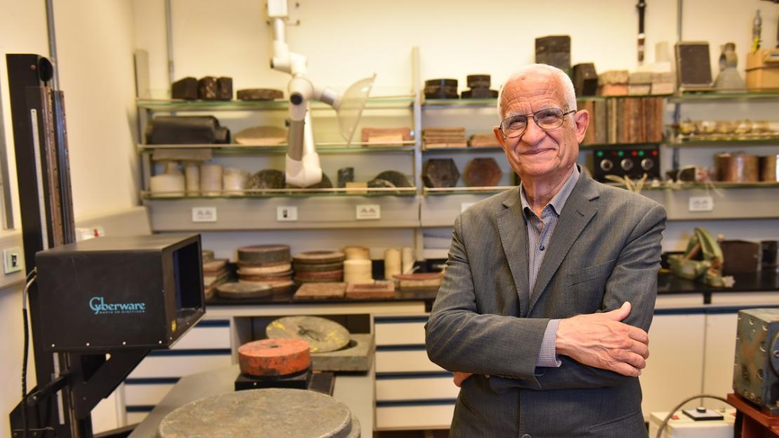 Man wearing a suit standing in an engineering lab