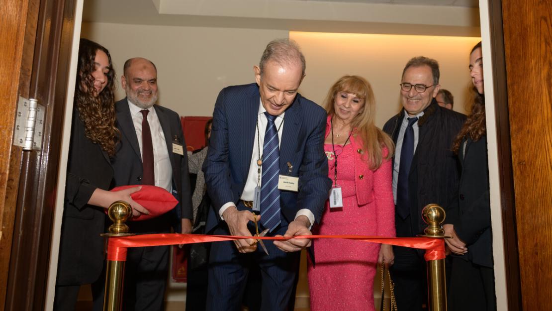Board members, man in suit cuts red ribbon at opening ceremony of Eltoukhy Learning Factory, with other men and women in suits behind him