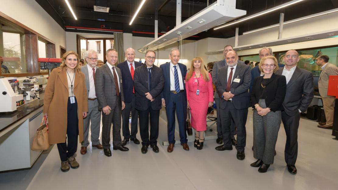 The Board of Trustees, faculty and staff visit Eltoukhy Learning Factory, pose in a line in front of lab equipment